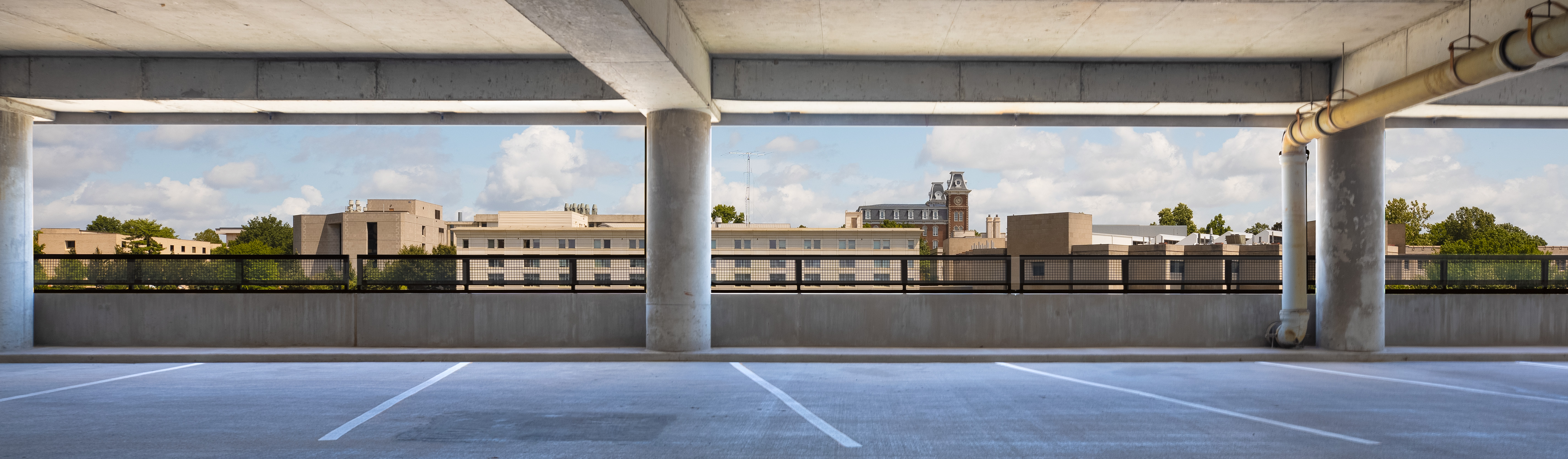 Hero image of harmon parking garage overlooking campus and Old Main tower